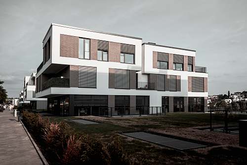 office building white and grey painted concrete building condo